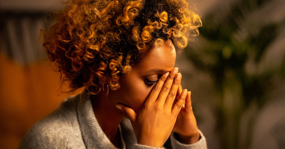 A woman looking stressed representing the complex journey of navigating emotional triggers