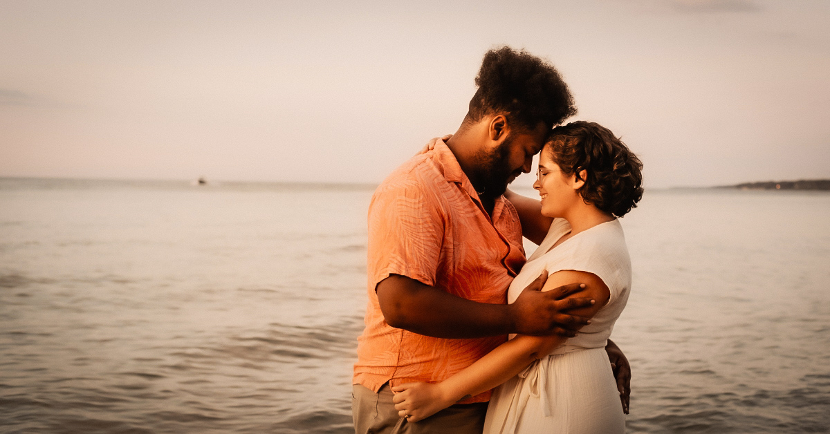 A man and woman lost in each other's gaze, symbolizing the connection between 'realistic' and 'unrealistic'.