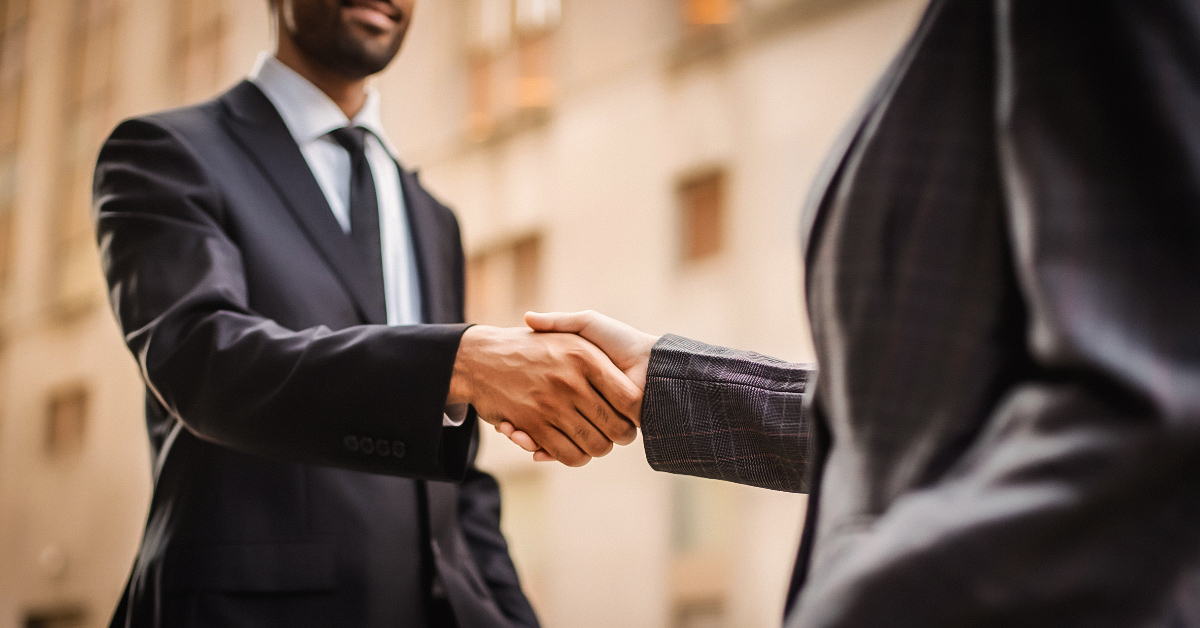 A confident man and woman engaging in a negotiation, symbolizing the salesmanship in dating.