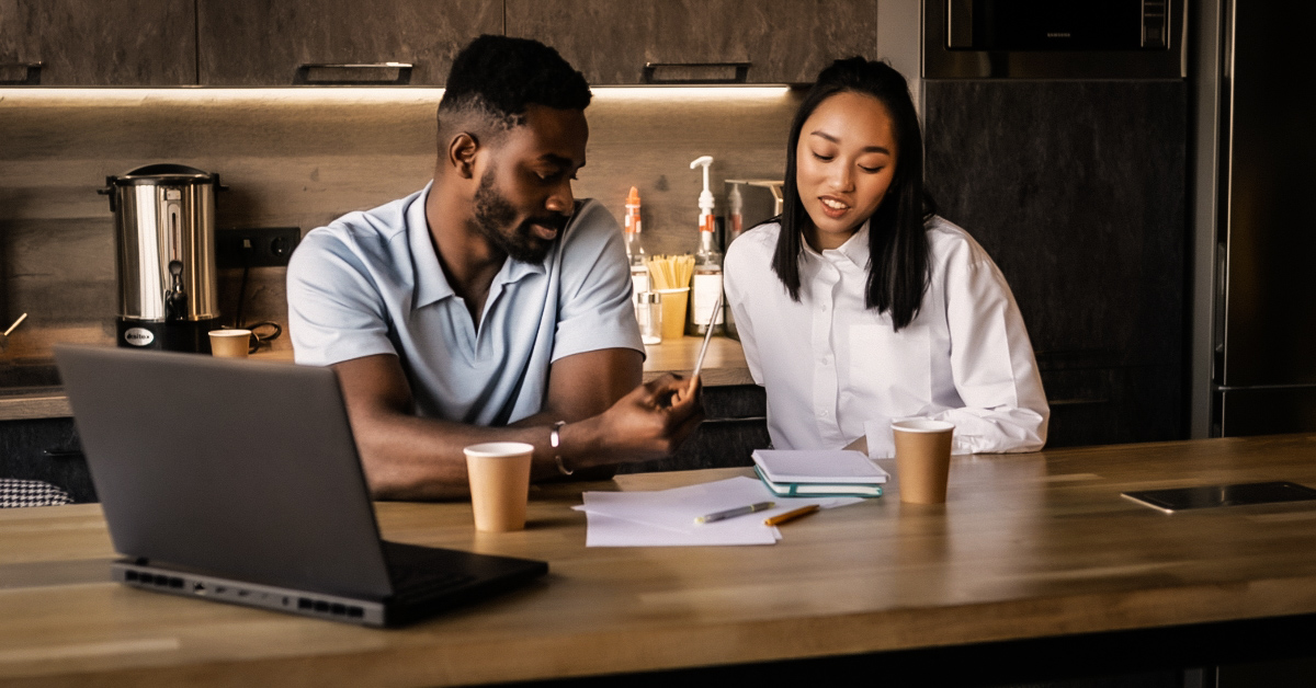 man working on his laptop while the woman provides him with supportive ideas, illustrating a successful partnership.