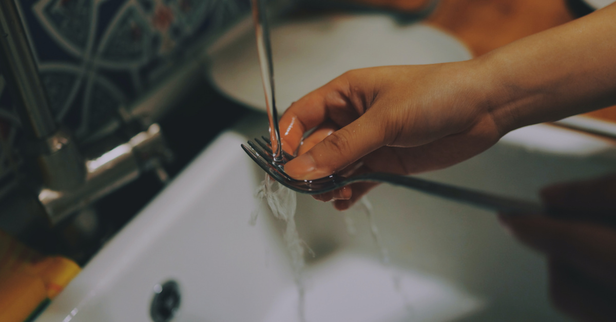 A thoughtful man washing dishes